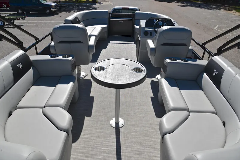 Slide: The Image of 2023 Viaggio DM18U pontoon boat interior with gray seating and central table. - 17