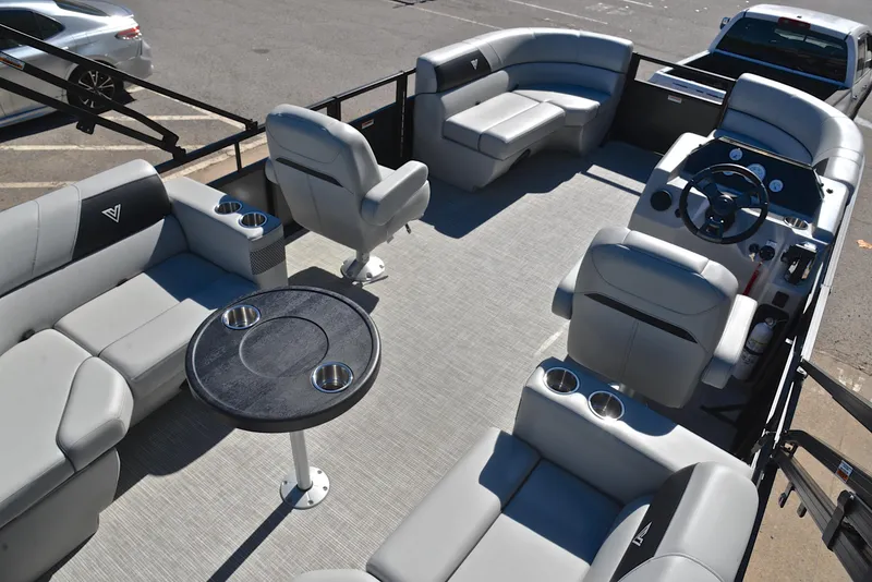Slide: The Image of 2023 Viaggio DM18U pontoon boat interior with gray seating and round table. - 18