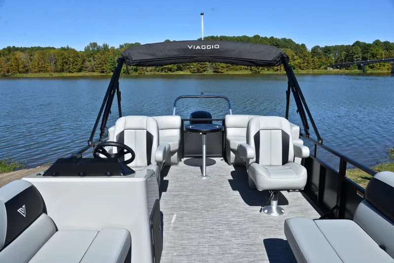 Slide: The Image of 2023 Viaggio DM18U pontoon boat on a serene lake with lush green surroundings. - 19