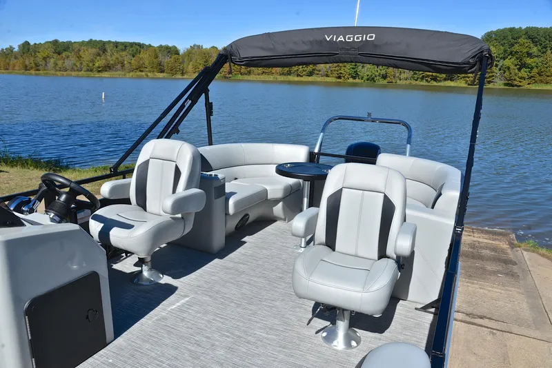 Slide: The Image of 2023 Viaggio DM18U pontoon boat with gray seating on a serene lake. - 21