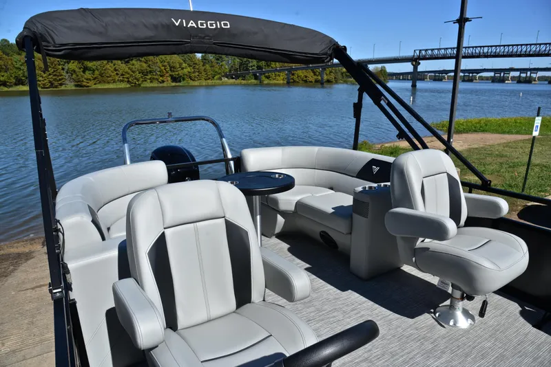 Slide: The Image of 2023 Viaggio DM18U pontoon boat with gray seating on a scenic river. - 22