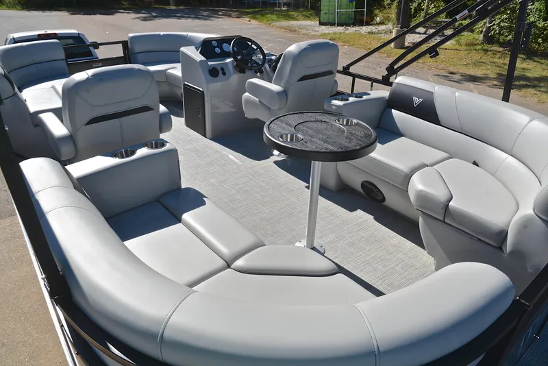 Slide: The Image of 2023 Viaggio DM18U pontoon boat interior with gray seating and central table. - 23