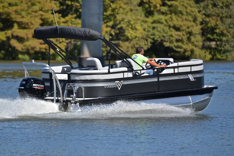 Slide: The Image of 2023 Viaggio DM18U pontoon boat cruising on a lake. - 5