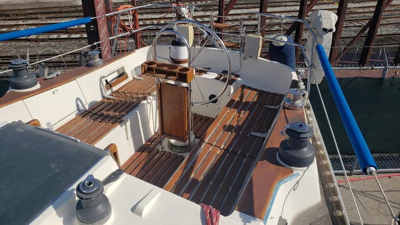 Slide: The Image of 1983 Wauquiez 38 MKI sailboat cockpit with wooden seating and steering wheel. - 10