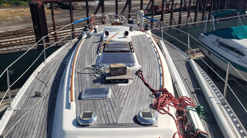 Slide: The Image of 1983 Wauquiez 38 MKI sailboat deck with wooden finish and ropes. - 14