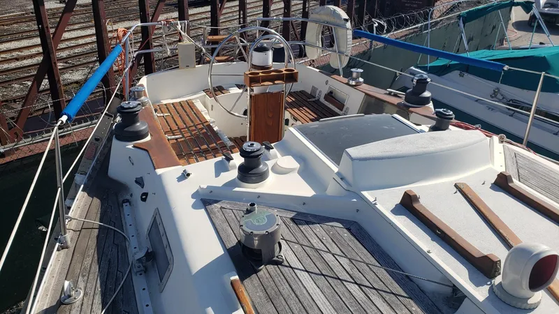 Slide: The Image of 1983 Wauquiez 38 MKI sailboat deck with steering wheel and winches. - 15