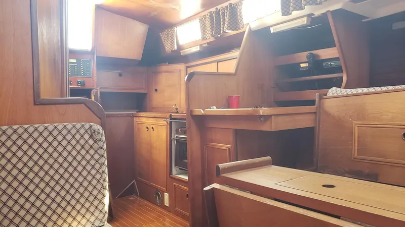 Slide: The Image of Interior of 1983 Wauquiez 38 MKI sailboat with wooden cabinetry and seating. - 19