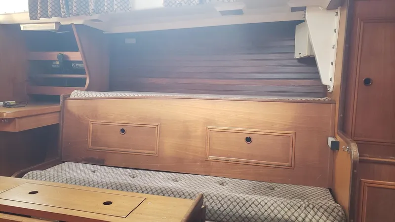 Slide: The Image of Interior of 1983 Wauquiez 38 MKI sailboat with wooden cabinetry and cushioned seating. - 20