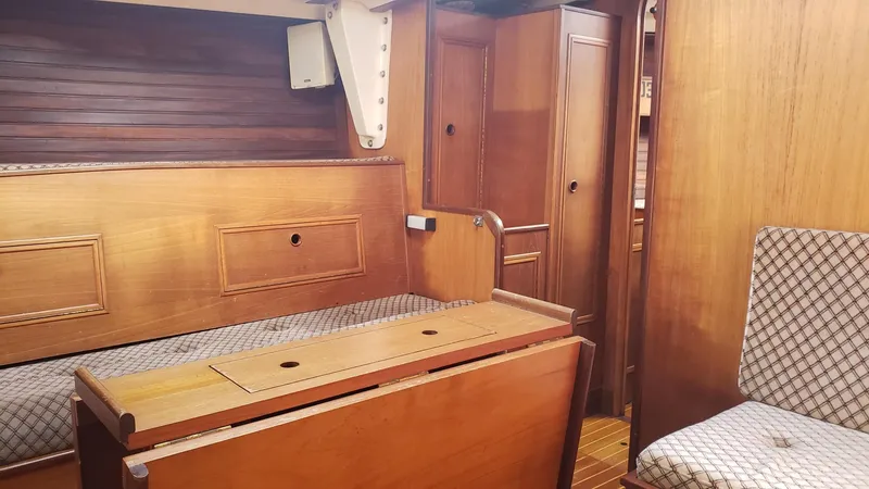 Slide: The Image of Interior of 1983 Wauquiez 38 MKI sailboat with wooden furnishings and seating. - 21