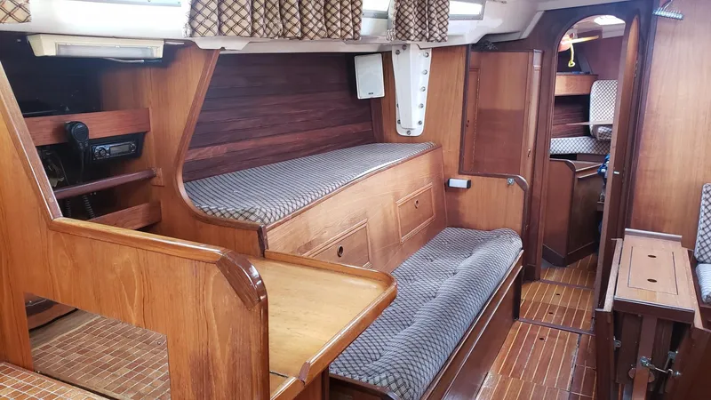 Slide: The Image of Interior of 1983 Wauquiez 38 MKI sailboat with wooden furnishings and cozy seating. - 22