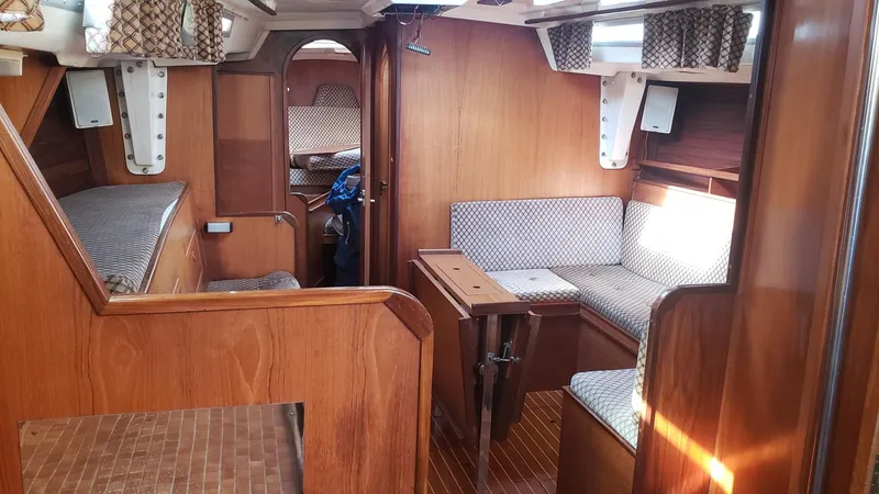 Slide: The Image of Interior of 1983 Wauquiez 38 MKI sailboat with wooden finish and cushioned seating. - 23
