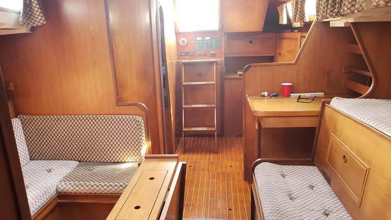 Slide: The Image of Interior of 1983 Wauquiez 38 MKI sailboat with wooden furnishings and seating. - 24
