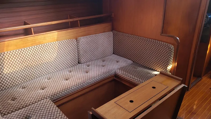 Slide: The Image of Interior of 1983 Wauquiez 38 MKI sailboat with cushioned seating and wooden accents. - 25