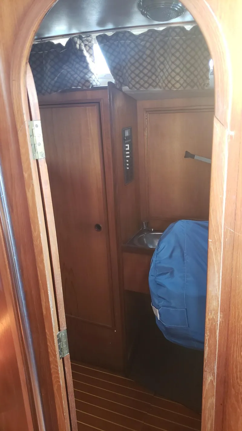 Slide: The Image of Interior of 1983 Wauquiez 38 MKI sailboat with wooden cabinetry and compact sink area. - 29