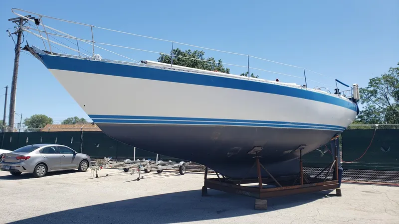 Slide: The Image of 1983 Wauquiez 38 MKI sailboat on dry dock under clear blue sky. - 3