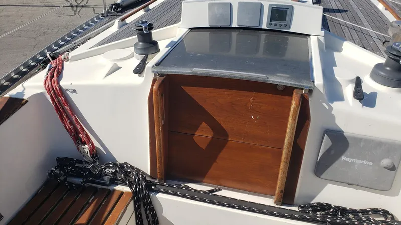 Slide: The Image of Cockpit of 1983 Wauquiez 38 MKI sailboat with wooden hatch and ropes. - 6
