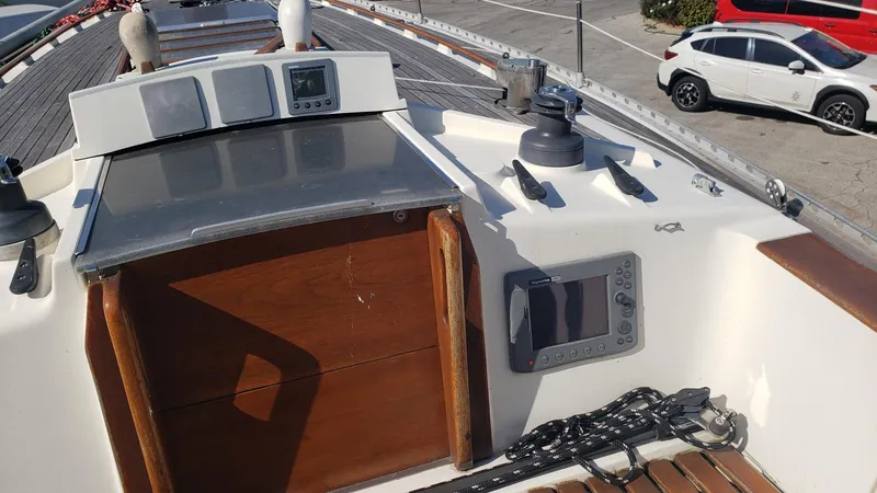 Slide: The Image of 1983 Wauquiez 38 MKI sailboat deck with navigation equipment and wooden hatch. - 7