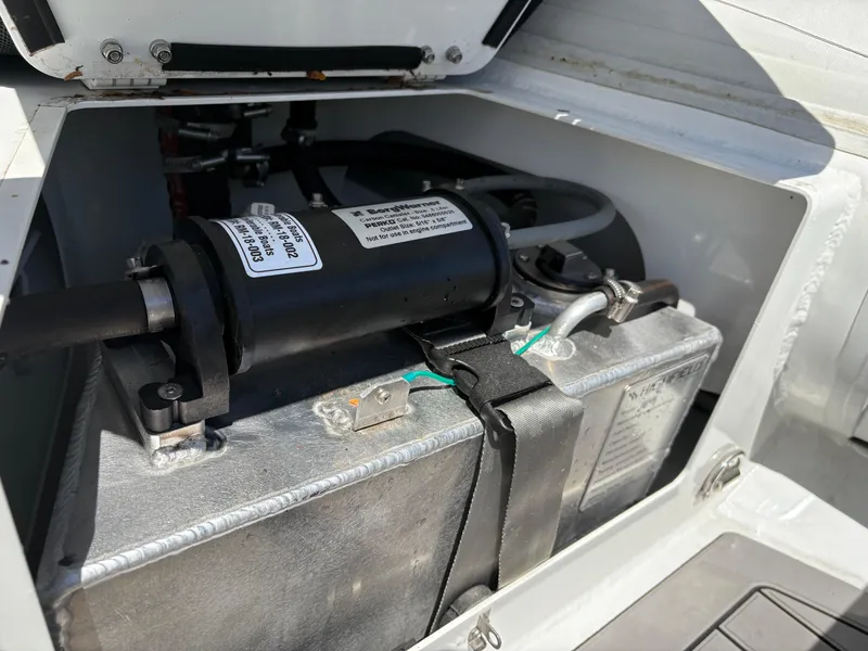 Slide: The Image of 2024 Highfield Sport 390 engine compartment with visible components and secure fittings. - 19