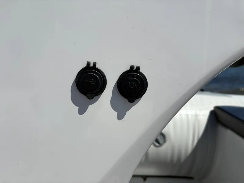 Slide: The Image of Close-up of two black plugs on a 2024 Highfield Sport 390 boat. - 22