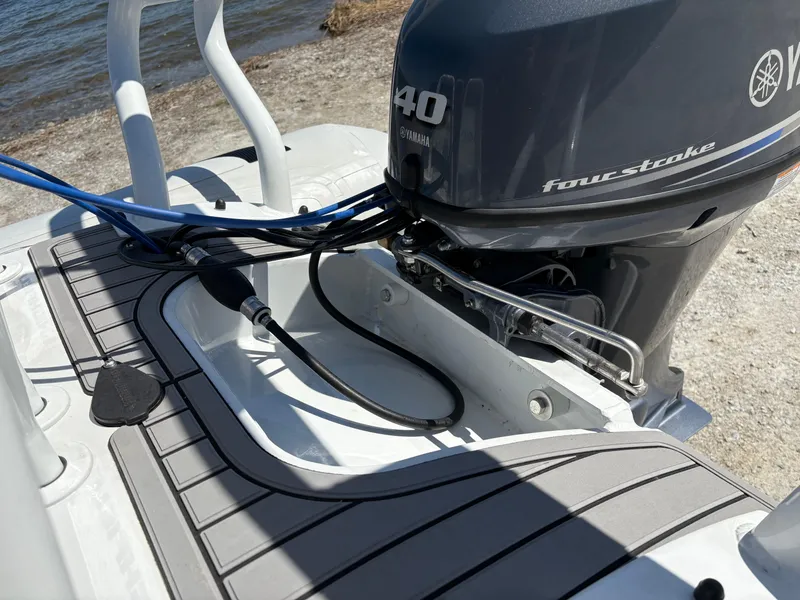 Slide: The Image of 2024 Highfield Sport 390 boat with Yamaha 40 four-stroke engine, docked by the water. - 25