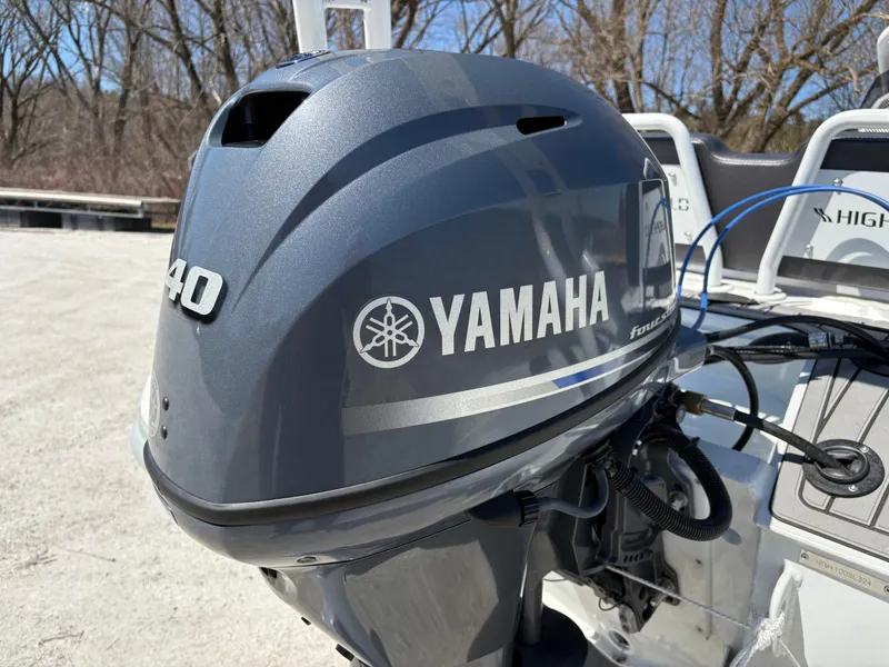 Slide: The Image of 2024 Highfield Sport 390 with Yamaha outboard motor, parked outdoors. - 7