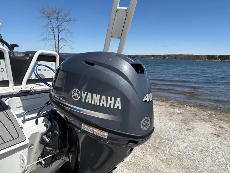 Slide: The Image of 2024 Highfield Sport 390 with Yamaha 40 outboard motor by a lake. - 8
