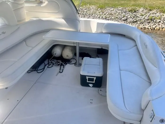 Slide: The Image of 2000 Sea Ray 410 Sundancer boat interior with white seating and table. - 11