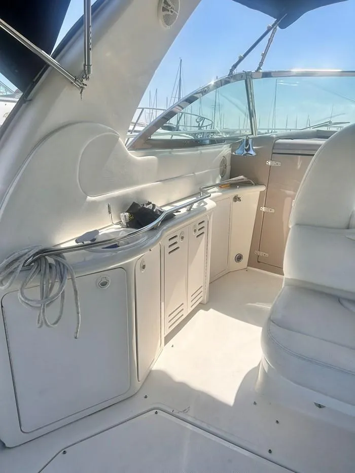 Slide: The Image of Interior of a 2000 Sea Ray 410 Sundancer yacht with white seating and cabinetry. - 13