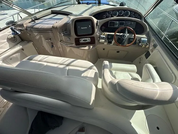 Slide: The Image of Interior cockpit of 2000 Sea Ray 410 Sundancer yacht with steering wheel and controls. - 2
