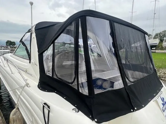 Slide: The Image of 2000 Sea Ray 410 Sundancer with black canvas enclosure at marina. - 6