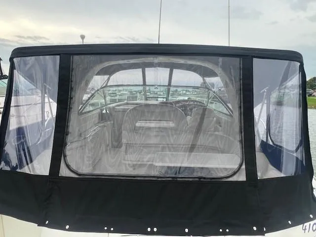 Slide: The Image of Sea Ray 410 Sundancer 2000 with black canvas enclosure, docked at marina. - 7