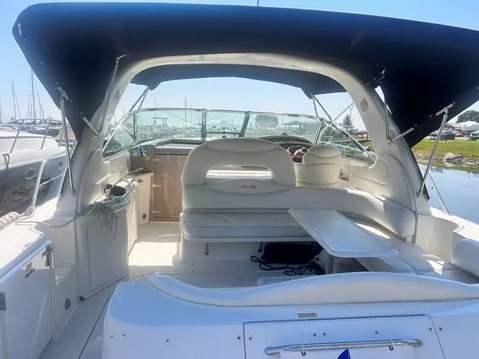 Slide: The Image of 2000 Sea Ray 410 Sundancer boat interior with seating and canopy. - 9