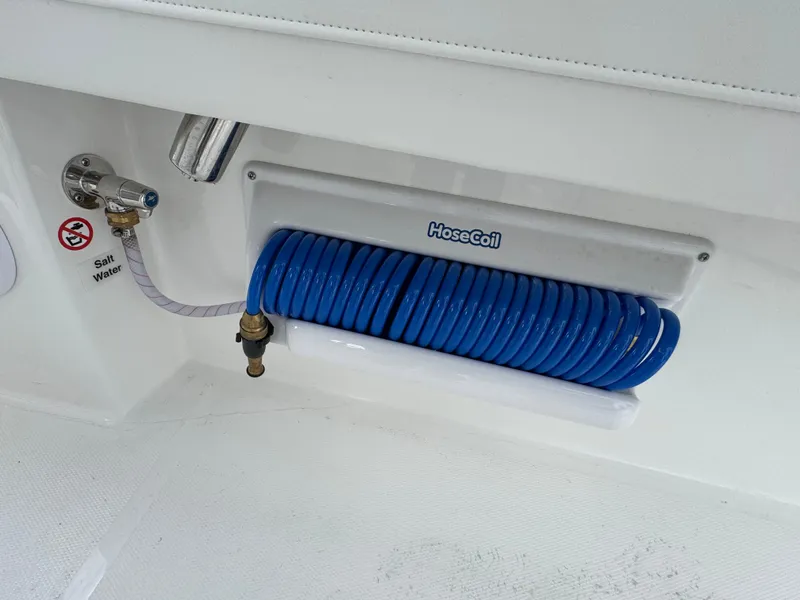 Slide: The Image of 2025 Regulator 23 boat with dual outboard motors and white seating. - 13