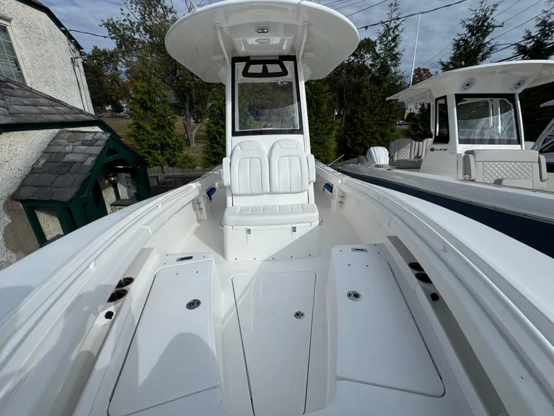 Slide: The Image of Regulator 23 boat 2025 model with blue HoseCoil and speaker detail. - 14