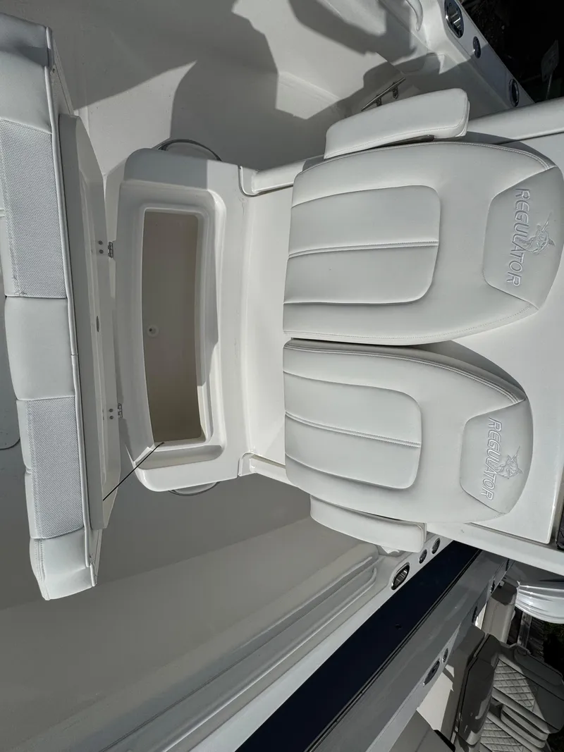 Slide: The Image of 2025 Regulator 23 boat interior with open storage compartments. - 17