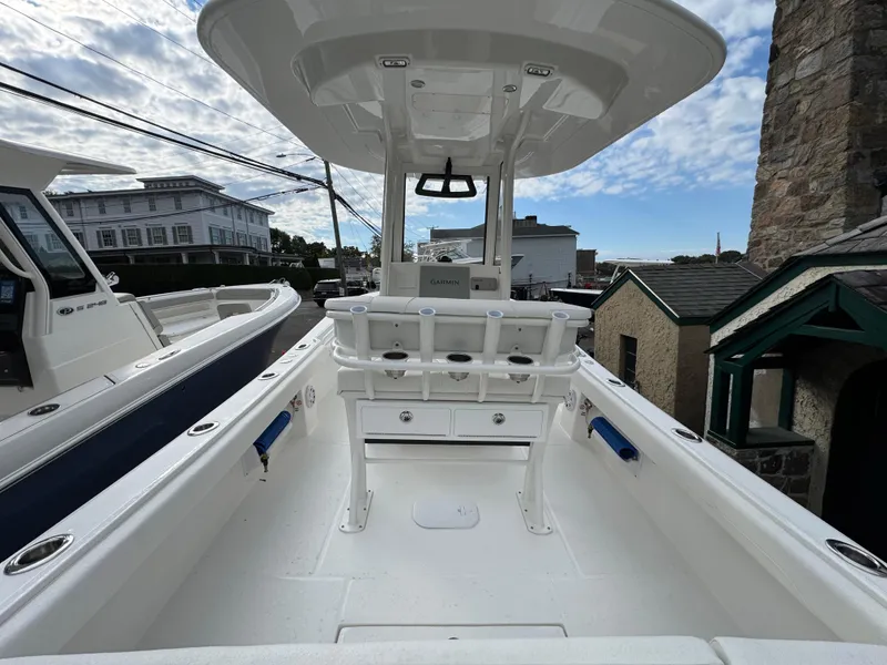 Slide: The Image of 2025 Regulator 23 boat with dual Yamaha 150 outboard engines, parked on gravel. - 3