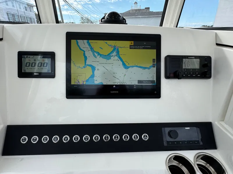 Slide: The Image of Yamaha 150 outboard motors on a 2025 Regulator 23 boat, parked outdoors. - 4