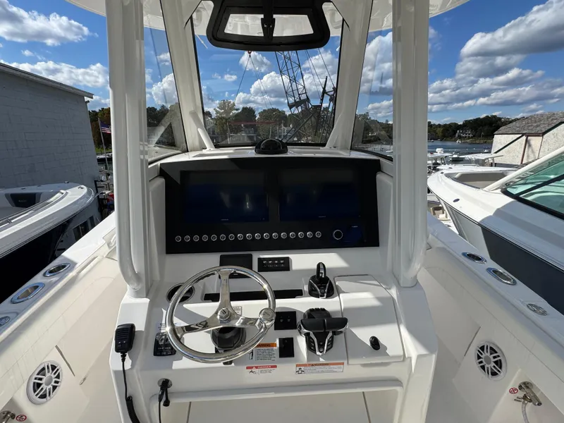 Slide: The Image of 2025 Regulator 28 boat cockpit with modern steering and navigation controls. - 12