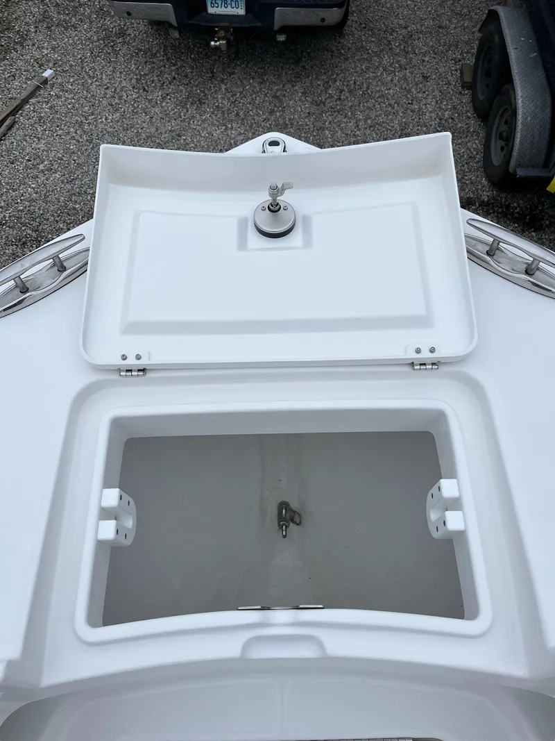 Slide: The Image of 2025 Regulator 28 boat anchor storage compartment, open lid view. - 19