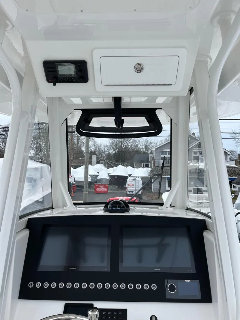 Slide: The Image of 2025 Regulator 28 boat dashboard with modern navigation displays and controls. - 23