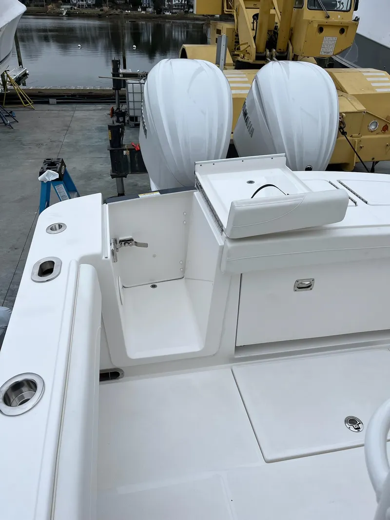 Slide: The Image of 2025 Regulator 28 boat with dual engines, docked near industrial equipment. - 29