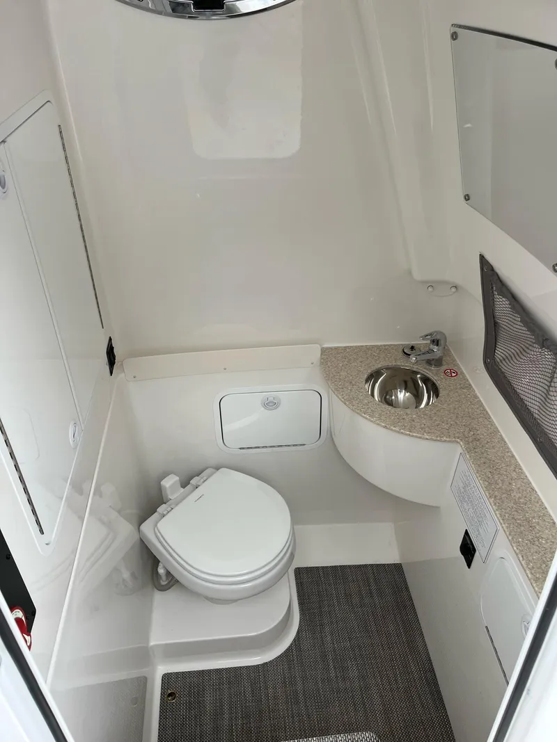 Slide: The Image of 2025 Regulator 28 boat interior bathroom with toilet and sink. - 31