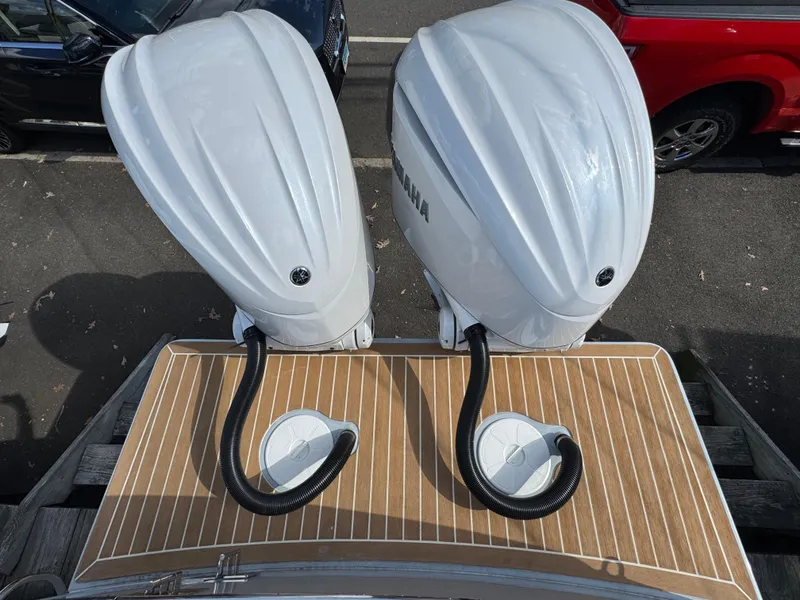 Slide: The Image of 2025 Regulator 28 boat with dual Yamaha outboard engines on a wooden deck. - 6