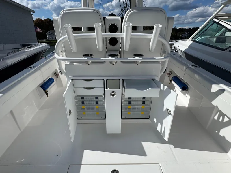 Slide: The Image of 2025 Regulator 28 boat interior with storage compartments and rod holders. - 9