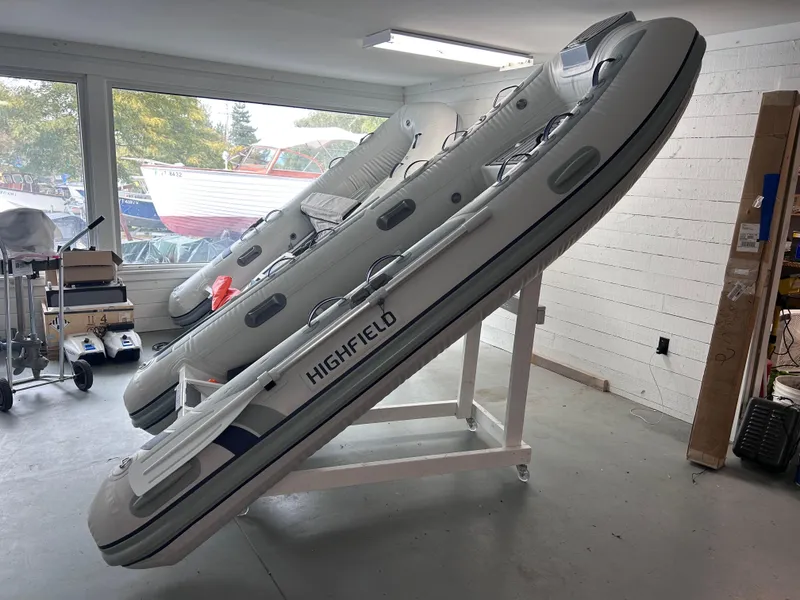 Slide: The Image of 2024 Highfield Classic 340 inflatable boats displayed indoors on stands. - 2