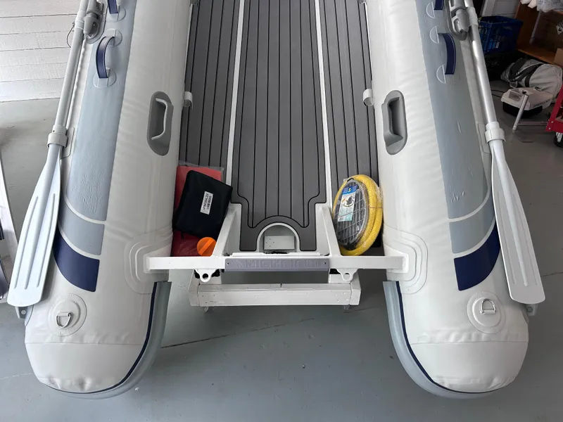 Slide: The Image of 2024 Highfield Classic 340 inflatable boat interior with oars and accessories. - 4