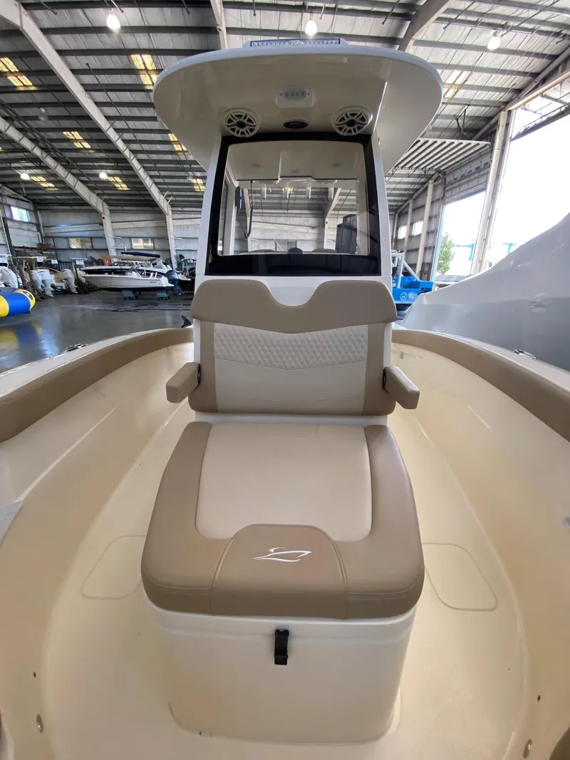 Slide: The Image of 2025 Scout 260 LXF boat interior in a warehouse setting. - 14