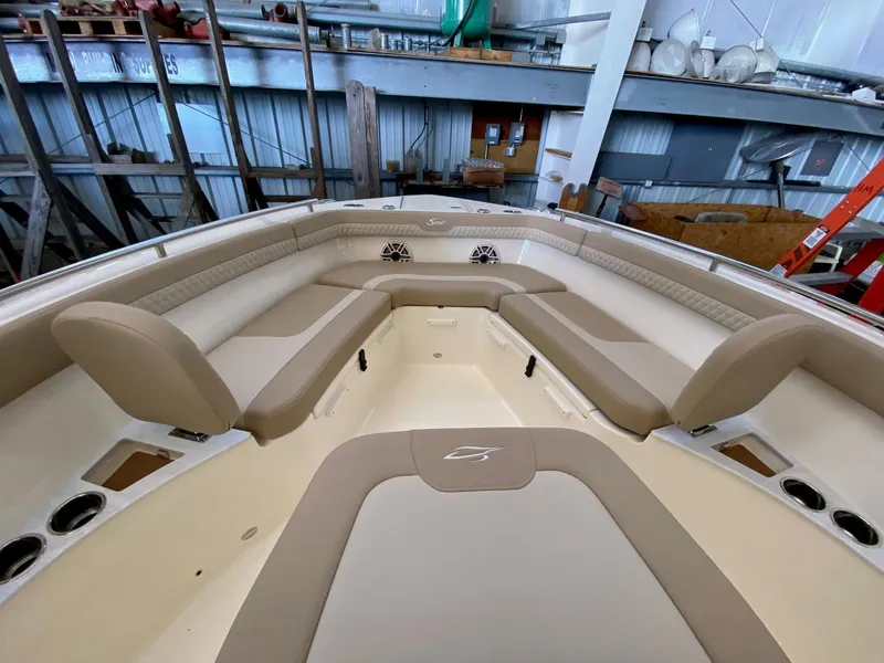 Slide: The Image of 2025 Scout 260 LXF boat interior with beige seating and storage compartments. - 15