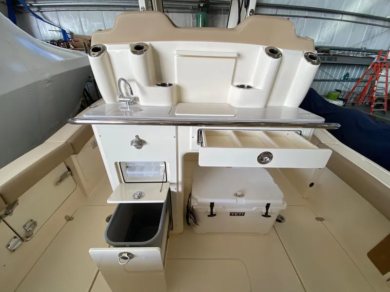 Slide: The Image of 2025 Scout 260 LXF boat interior with storage compartments and sink. - 17