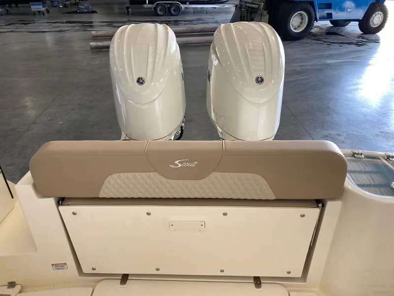 Slide: The Image of 2025 Scout 260 LXF boat with dual outboard engines in a garage setting. - 18